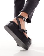 Trombone chunky buckle detail flatforms in black